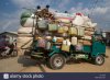 overloaded-truck-with-passengers-on-the-top-at-a-market-south-of-inle-FT11WR.jpg