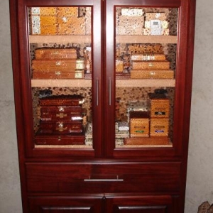 The armoire I made in 2008.  It's Mahogany with seedy glass doors on top, raised panels on the bottom.  Center drawer is for singles.  Humidification is an Accumonitor 4 canister system that works beautifully. Of course the interior is solid Spanish Cedar.