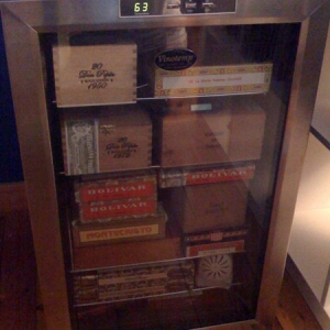 My Vinotemp wine coolerdor. Setup includes: Vinotemp 28-bottle thermoelectric wine cooler ($150) Ranco ETC external temperature controller ($75) Cigar Oasis Plus XL ($110) 1 Pound 65% Rh Heartfelt Beads ($30) Oust fan ($4). Depending on the size/arrangement, I can fit 16 to 22 boxes of cigars.