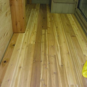 Cedar T&G flooring. I left a 1" space between the flooring and walls to allow for air flow under the floor.