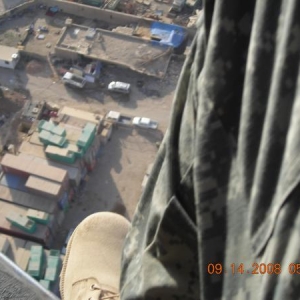 feet out of a blackhawk somehwere over baghdad