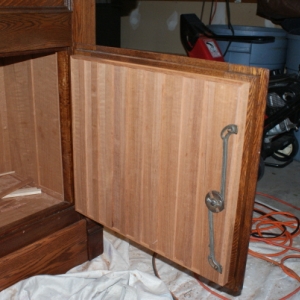 The lower cabinet door, board and batten with 1/4" Spanish Cedar.  The original lock mechanism is reinstalled.