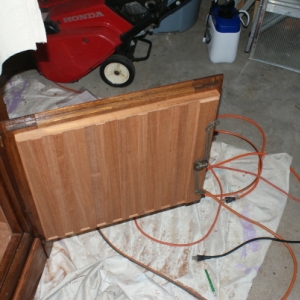 The lower cabinet door, board and batten with 1/4" Spanish Cedar.  The original lock mechanism is reinstalled.