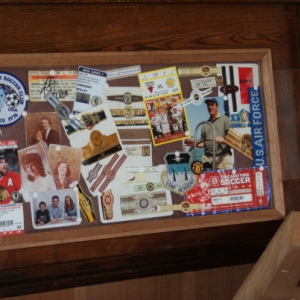 The top lid open.   This is the "shadow box" I put in.  The original ice box had the same thing except it was built out of oak (which was rotted), and had a metal insulated panel in the center.  I rebuilt the same configuration out of spanish cedar, and made the center panel the shadow box.  The stuff in the shadow box is just a random collection of old photos, sports tickets, cigar bands, coaching stuff etc.  With not too much effort, I can change what's in the shadow box too.