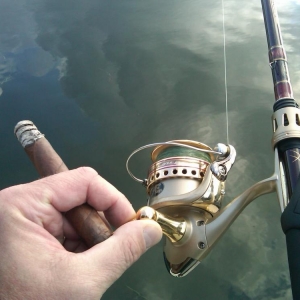 rod, reel, reflections of the sky, and of course, a cigar