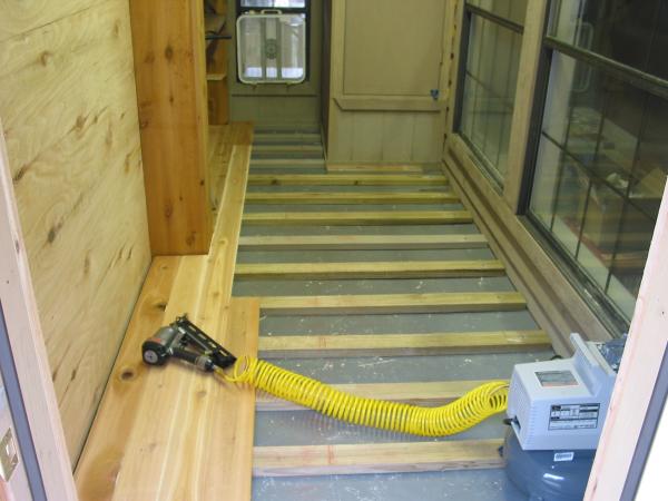 Nailing down T&G flooring with 2.5" 15ga galvanized trim nails.