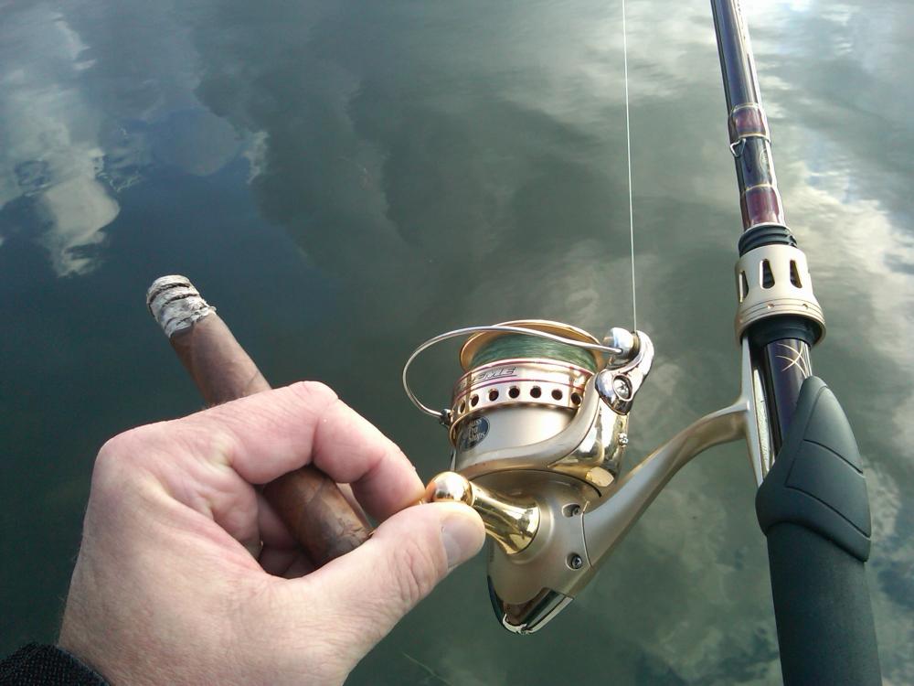 rod, reel, reflections of the sky, and of course, a cigar