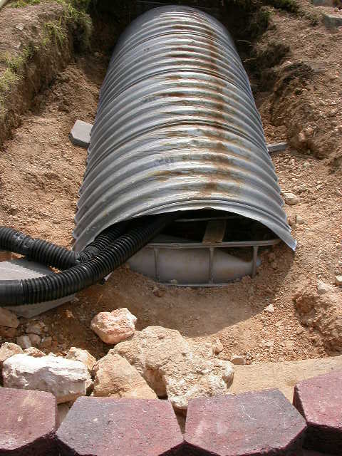 Tanks covered with steel culvert half