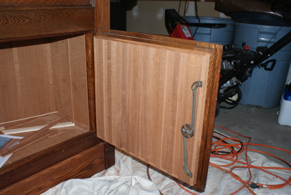 The lower cabinet door, board and batten with 1/4" Spanish Cedar.  The original lock mechanism is reinstalled.