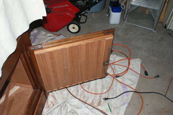 The lower cabinet door, board and batten with 1/4" Spanish Cedar.  The original lock mechanism is reinstalled.