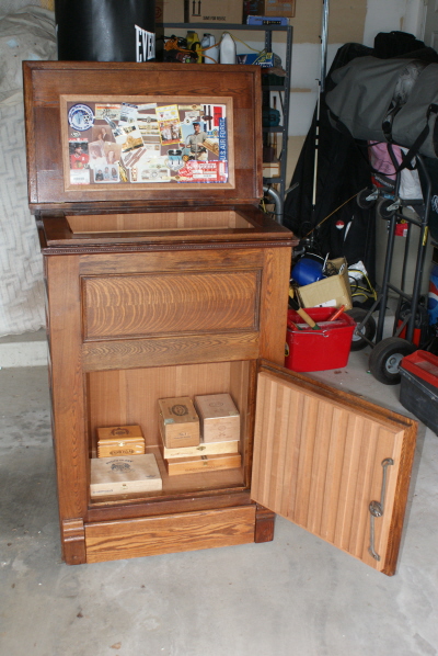 Top lid open, bottom cabinet door open, with some empty boxes.