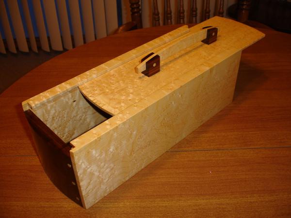 Wine bottle box that I made for a bomb a couple years ago.  Looking back, I wish I'd have kept this, it was a neat project.  Birdseye Maple with Black Walnut ends.  Slide lid top.