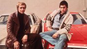 actors-David-Soul-and-Paul-Michael-Glaser-sitting-on-the-hoods-of-their-cars-from-the-televisi...jpg